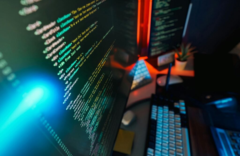 pexels-photo-33433724-33433724 Futuristic workspace featuring a glowing computer screen with coding displayed, ideal for technology and programming concepts.